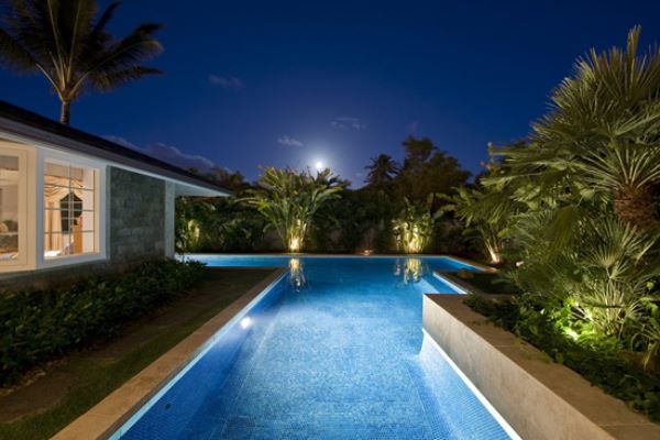 Pool terrace and tropical planting, lit at night
